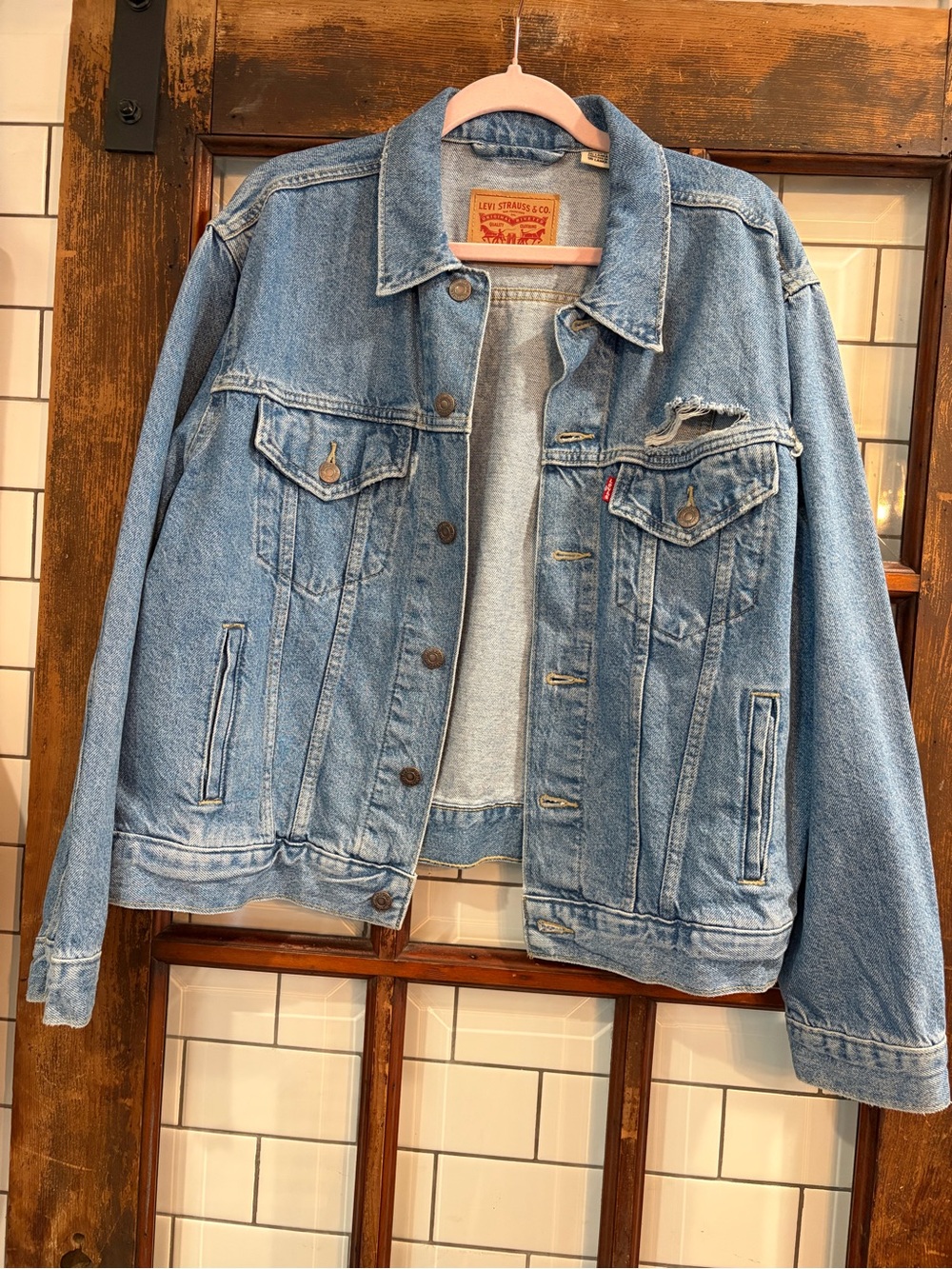 Women’s Levi's denim jacket features a distinct frayed rip size  X-LG